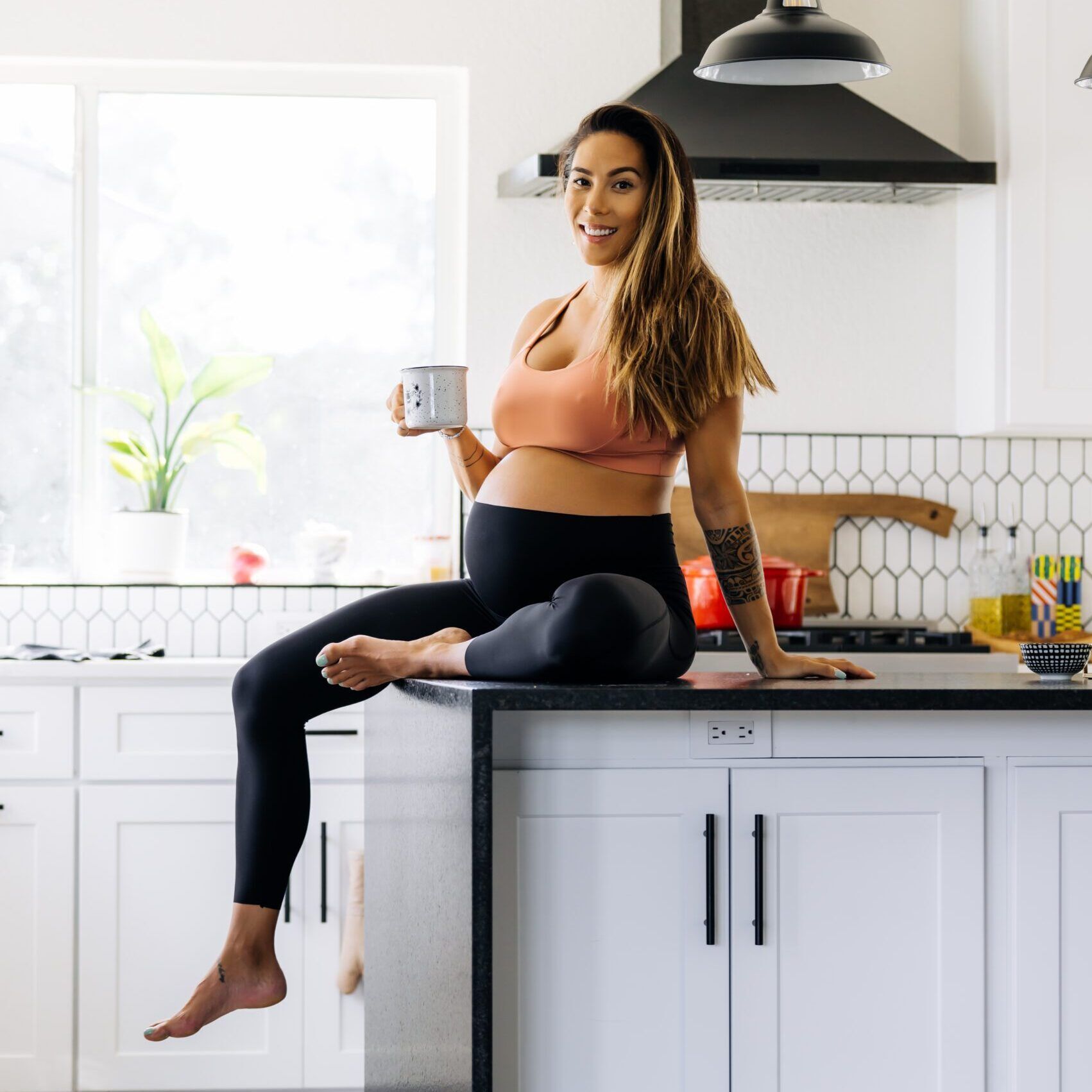 HANNAH EDEN, PREGNANT, SITTING ON KITCHEN COUNTER