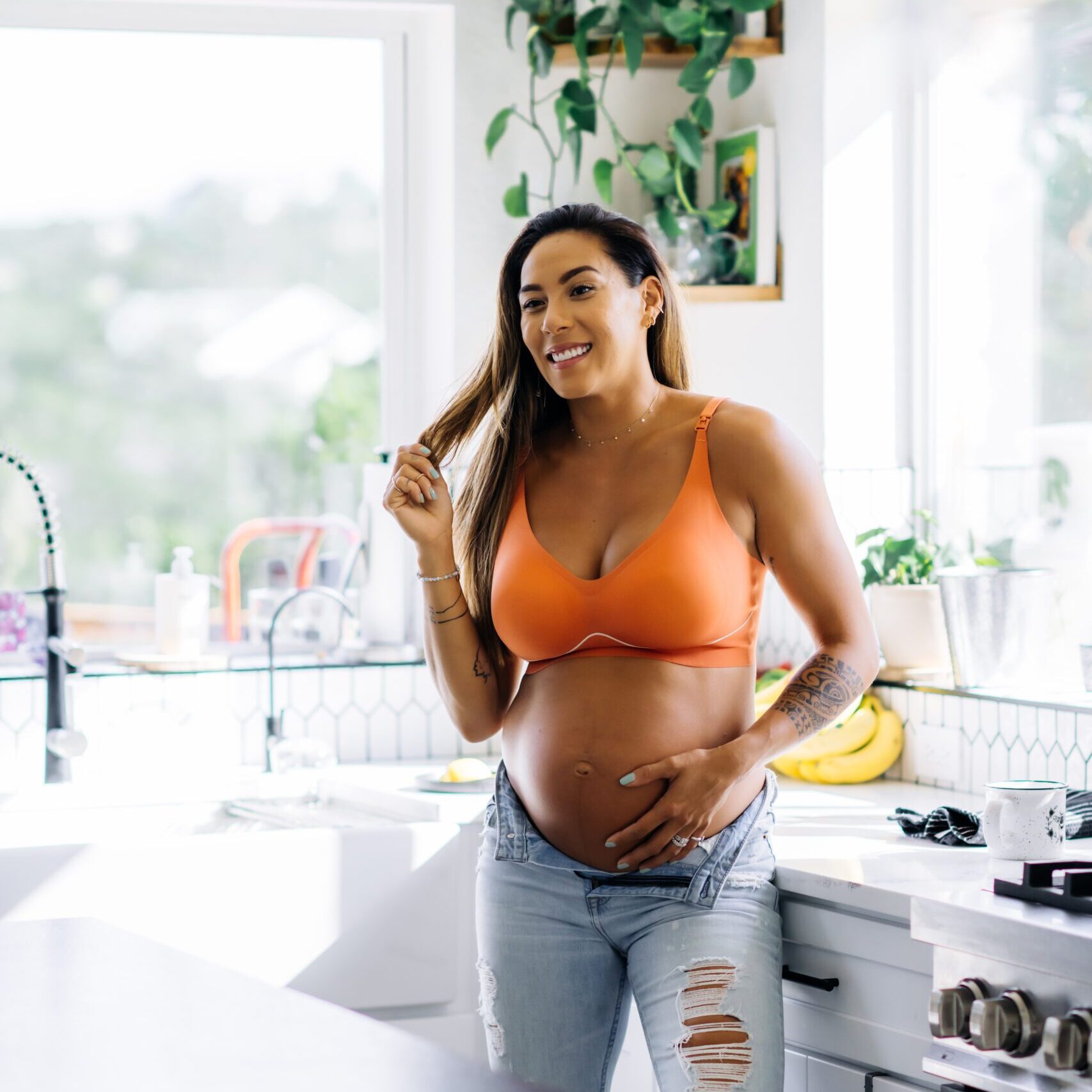 BUMPFIT | EVERYTHING BRA HANNAH EDEN, PREGNANT, STANDING IN THE EVERYTHING NURSING BRA FROM FYR APPAREL